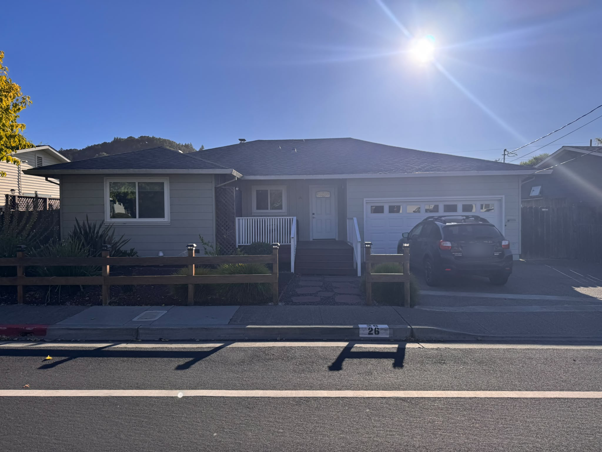 Front exterior of the home with a two-car garage, covered porch, and landscaped front yard